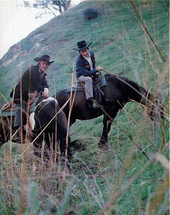 Fig.2 Photograph of Joe Goode and Ed Ruscha wearing cowboy hats on horseback on a green hillside