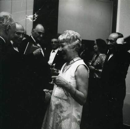 Fig.2 Peggy Guggenheim and Norman Reid surrounded by guests at the opening of The Peggy Guggenheim Collection, Tate Gallery, London, 1 January 1965