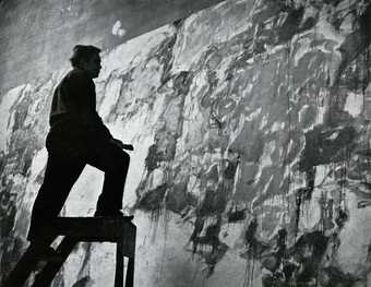 Fig.37 Sam Francis on a ladder in front of one of the Basel Mural canvases in his Arcueil studio, Paris, c.1958