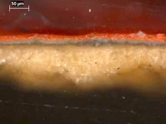 Fig.3 Cross-section of paint through the red costume at the lower edge of the painting, photographed at x320 magnification.