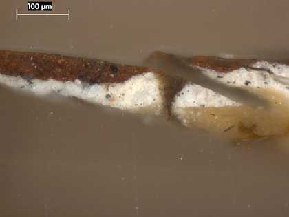 Fig.3 Cross-section through the dark red trousers at the bottom edge, photographed at x250 magnification. From the bottom: chalk ground; greyish beige priming; dark red paint