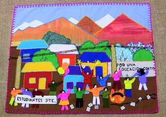 Brightly coloured textile collage: in the background are houses and trees in front of mountains; in the foreground figures wave arms in the air and hold up signs reading e.g. POR UNA EDUCACION GRATIS