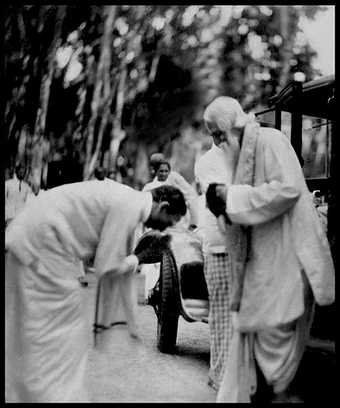 Black-and-white photography of two people, one bowing deeply to the other
