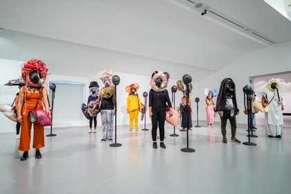 Fig.3 Kevin Beasley Your face is / is not enough 2016, performance at Liverpool Biennial 2018, Tate Liverpool, 14 July 2018 Microphone stands, gas masks, megaphones, polyurethane foam, polyurethane resin, clothing, feathers, baseball caps, umbrella frame