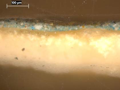 Fig.4 Cross-section through green foliage in the lower left corner, photographed at x320 magnification. From the bottom: white ground; bright, opaque bluish green underpainting; translucent green glaze