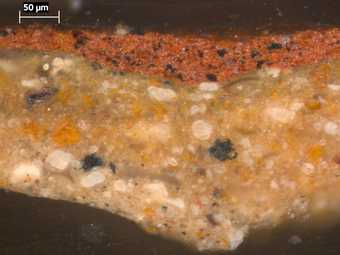 Fig.4 Cross-section through the red seal at the lower left edge, photographed at x320 magnification. From top to bottom it shows: three applications of tan coloured ground; opaque red paint of the seal; an accumulation of varnish and dirt