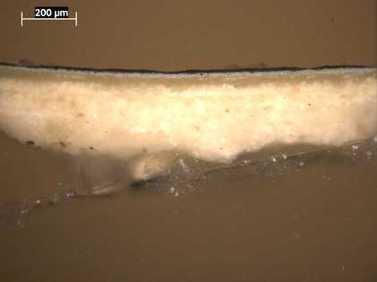 Fig.5 Cross-section through the black cloak, photographed at x100 magnification. From the bottom: white ground; opaque pale grey priming; black paint of cloak