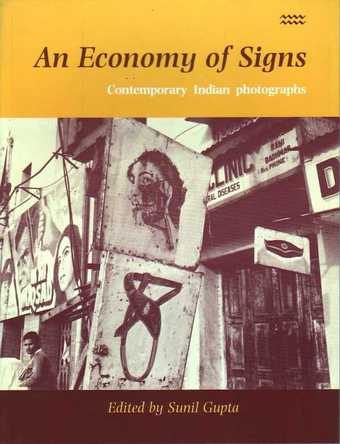 The front cover of a book featuring a photograph of street signs and posters.