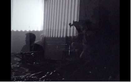 Still from Tyler Hubby’s film of the performance of Ten Years Alive at the Empty Bottle, Chicago, 1996, showing the musicians playing their instruments