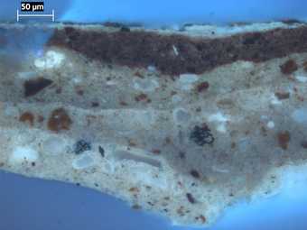 Fig.5 The same cross-section as fig.4 photographed in ultraviolet light. It shows the three coats of ground more clearly, ditto the varnish and dirt