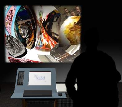 An individual stands next to a computer screen and in front of a colourful, distorted image that is projected on the wall.