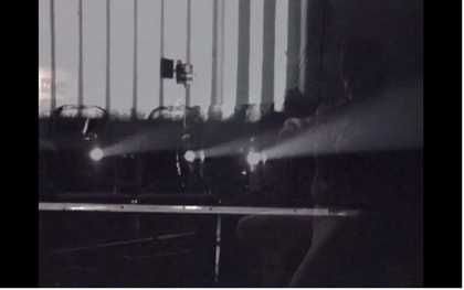 Still from Tyler Hubby’s film of the performance of Ten Years Alive at the Empty Bottle, Chicago, 1996, showing the projector
