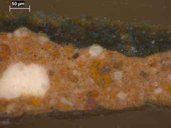 Fig.7 Cross-section through green foliage, photographed at x320 magnification. From the bottom: upper layer of ground; green paint with large particles of azurite, raw sienna and ground glass in a dark green matrix