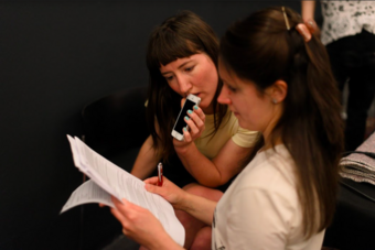 Fig.7 New performers Emily Lansley (centre) and Catherine Landen (right) discussing the ‘dossier for transmission’ during rehearsals for the LightNight performance at Tate Liverpool, 2019 Photo: Roger Sinek