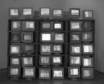 A display of thirty-six computer monitors presented in a grid-like structure.