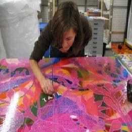 Conservator Natasha Walker applying the Tate logo in oil paint dots to the full-scale mock-up of Mono Rosa (Pink Monkey) to distinguish it from the original