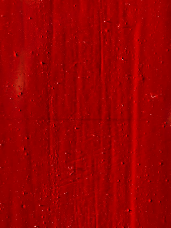 A detail of the deep red surface of Red Barn Door showing small solid flecks and vertical and horizontal scratches and marks.