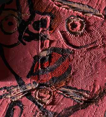 Detail of face under raking light from left showing wrinkled paint