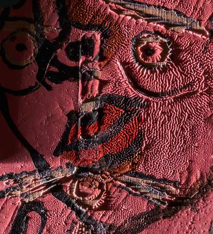 Detail of face under raking light from left showing wrinkled paint