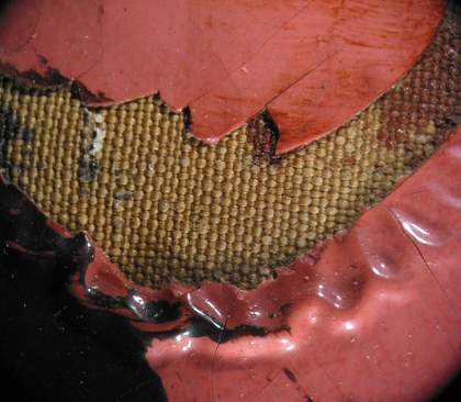 Detail of area around the mouth of the male head showing wrinkled paint