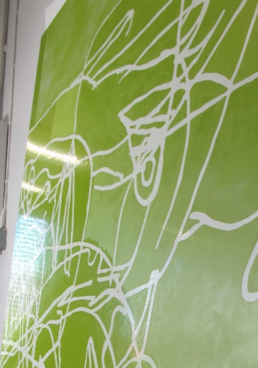 A large section of Water Painting photographed at an angle, with the cleaned area on the left appearing glossy and reflecting light, and the untreated area on the right appearing matte.