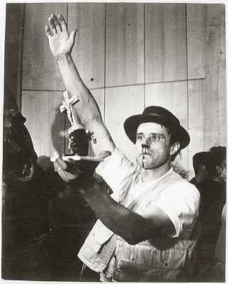 Joseph Beuys photographed during performance at Fluxus Festival of New Art, Aachen, 20 July 1964