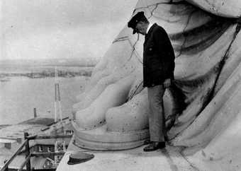 Superintendant at the foot of the Statue of Liberty, c.1930s