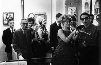 A visitor shooting at Niki de Saint Phalle’s Feu à Volonté exhibition, Galerie J, Paris 1961