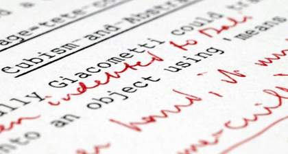 A close up photograph of a typewriter piece of text with red handwriting in between the lines