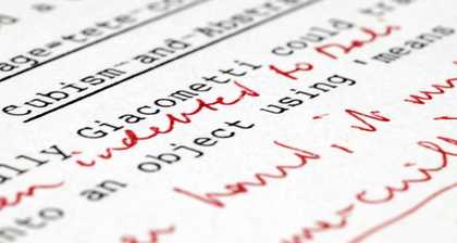 A close up photograph of a typewriter piece of text with red handwriting in between the lines