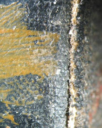 Detail of front edge of emery fabric with remnants of black paint