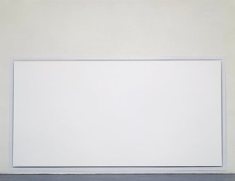 A photograph of a large white canvas hanging just off the floor in a gallery space.