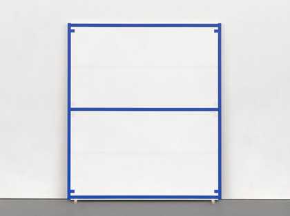 A painting of blue lines and tabs enclosing white spaces, standing on wedges and leaning against a gallery wall.