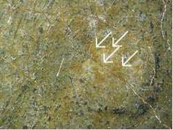 A detail of a patch of brown discoloured varnish on the painting