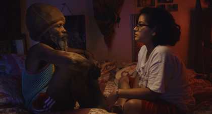 Profile of an old man and a young girl looking at each other