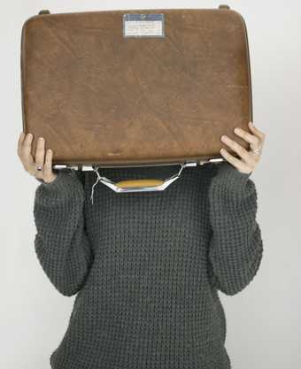 A woman holding a suitcase