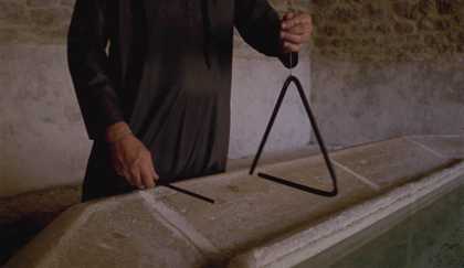 torso of a man holding a triangle