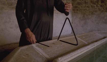 torso of a man holding a triangle