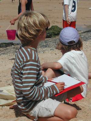 Kid drawing on beach