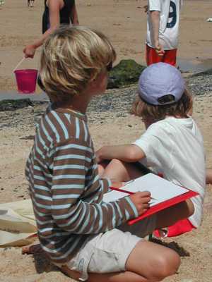 Kid drawing on beach