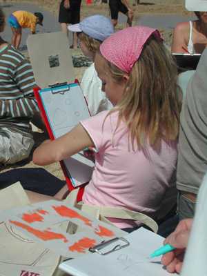 kid using a viewfinder to make her collage