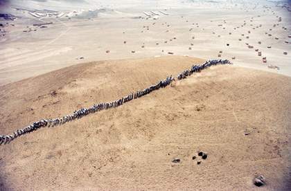 Video still from Francis Alyss When Faith Moves Mountains documentation of an action near Lima Peru 2002