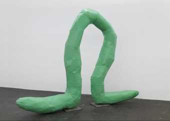 Photograph of Franz West Omega 2008. Shows a green tubed sculpture in a gallery