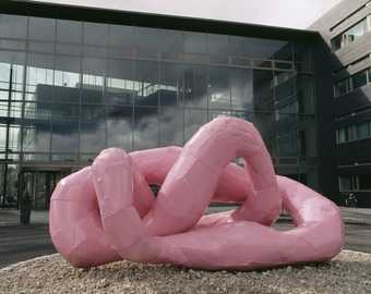 A pink sculpture which takes the form of a knotted shape
