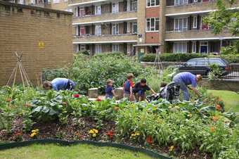 Fritz Haeg Edible Estates 2007, showing children and adults working in a community garden