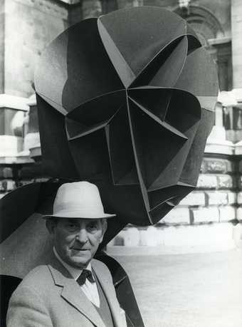 Naum Gabo with Head No.2 1916 outside Tate Britain in 1964