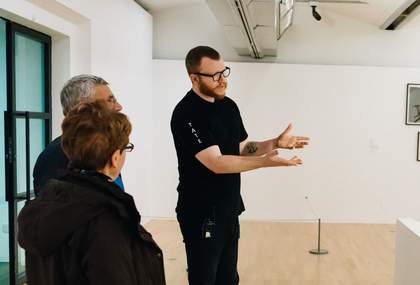 Visitor Assistant talking to visitors