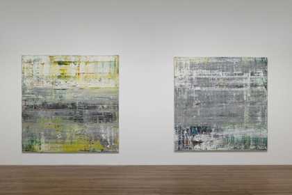 Two square paintings hung side by side on a white wall.