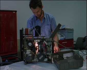 technician with lense and projector