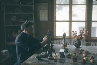 Alberto Giacometti modelling a bust in his studio in Stampa. Switzerland in 1965, photographed by Ernst Scheidegger